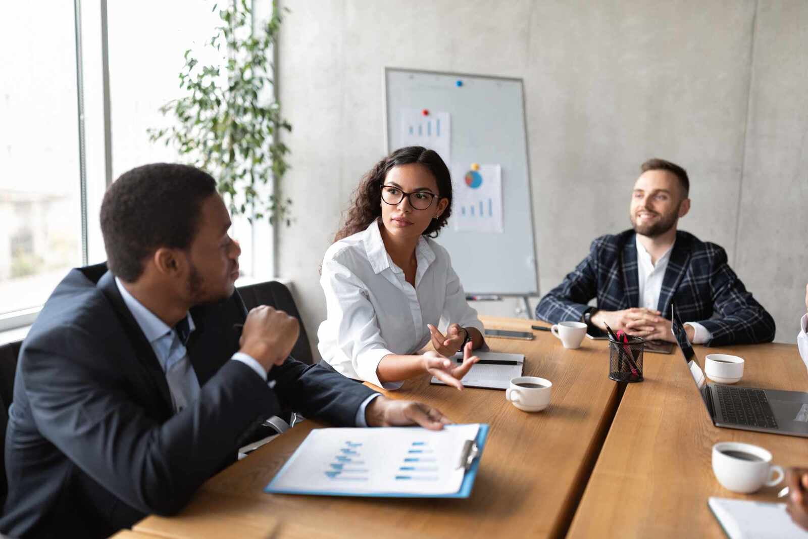 coworkers-at-corporate-meeting-discussing-work